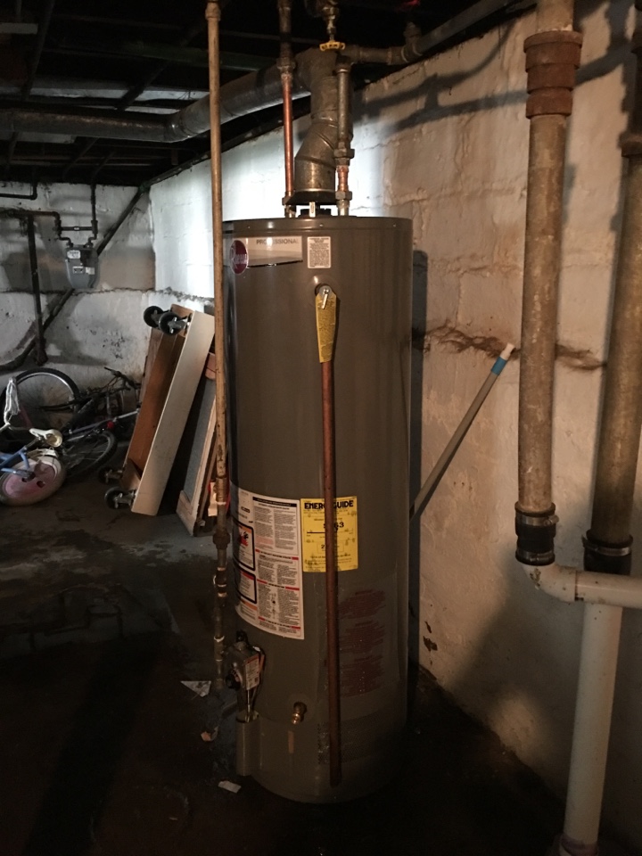 Removing an old Kenmore water heater and replaced with. Rheem 40 gallon water heater. in N Kilbourn Ave, Chicago, IL, USA.